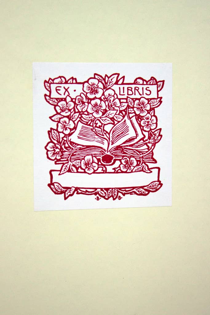 Decorative print with floral design and 'Ex Libris' text on a beige background