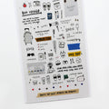 A travel-themed notebook with various illustrations related to travel, such as a suitcase, plane, and sunglasses, along with text that reads 'Bon voyage' and 'One day'.